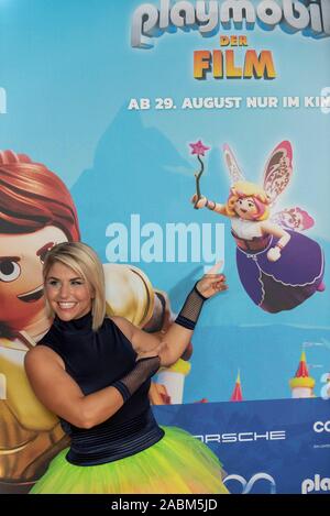 The actress in the Playmobil film Beatrice Egli poses at the film premiere on Sunday, August 4, 2019 at the Mathäser Filmpalast in Munich (Upper Bavaria) next to her character the good fairy for a photo on the red carpet. [automated translation] Stock Photo