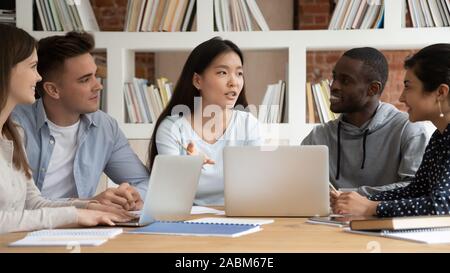 Asian female team leader explaining new school research project details. Stock Photo