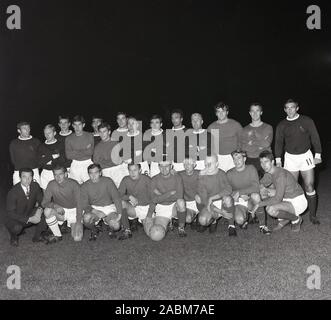 1965, historical, evening time and a group picture of two football teams, one being Tring FC, showing the boots and kit of the era, with the traditional crewneck. Note the lack of sponsors names/logos on their jerseys. Stock Photo