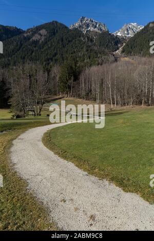 Curvy dirt path leading to mountains Chamonix Stock Photo