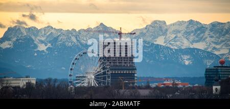 Munich, Germany. 28th Nov, 2019. The big wheel 'Hi-Sky München' and a skyscraper under construction can be seen in foehn weather off the Alps more than 100 kilometres away. (The picture was taken with an 800 millimeter telephoto lens.) Credit: Peter Kneffel/dpa/Alamy Live News Stock Photo