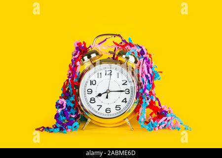 Old alarm clock on a yellow background Stock Photo