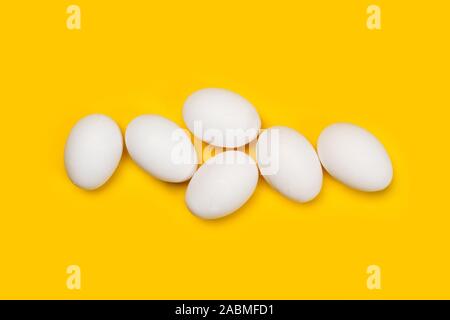 White eggs on a yellow background Stock Photo