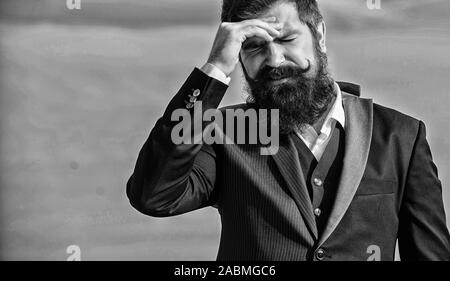 Business failure. Man bearded stressful painful face sky background. Guy suffer headache stressful day. Stressful business. Pain and migraine. Frustration and disappointment. Unforgivable mistake. Stock Photo