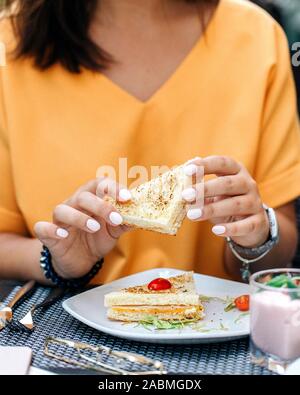 woman holding sandwich in hands Stock Photo