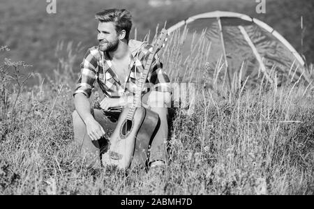 Musician looking for inspiration. Summer vacation highlands nature. Dreamy wanderer. Pleasant time alone. Peaceful mood. Guy with guitar contemplate nature. Wanderlust concept. Inspiring nature. Stock Photo
