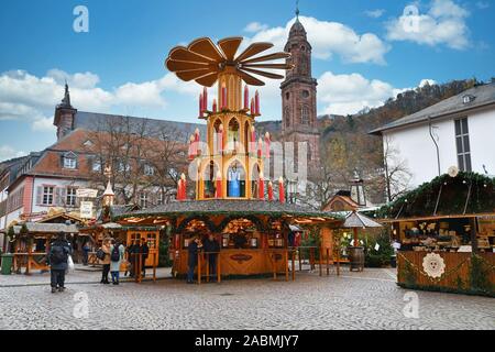 Heidelberg, Germany - September 2019: Massive holiday pyramid with candles as part of traditional Christmas market on universiry square in city Stock Photo