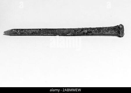 rusty nail covered with a brown oxidant on a white background Stock Photo