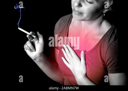 Woman smokes cigarette and has problem with lungs or heart attack. Nicotine addiction concept Stock Photo