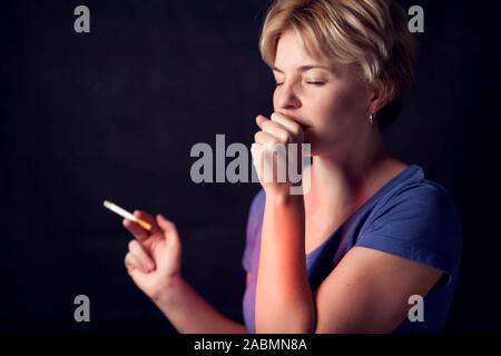 Woman smokes cigarette and has problem with lungs or heart attack. Nicotine addiction concept Stock Photo