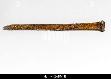 rusty nail covered with a brown oxidant on a white background Stock Photo
