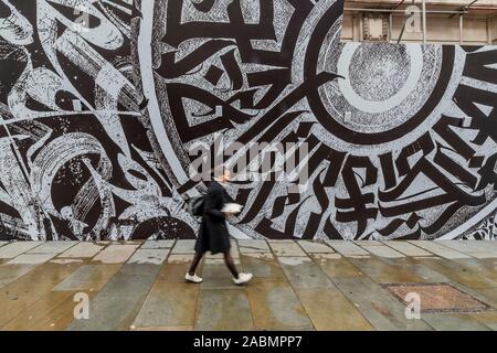 London, UK. 28th Nov 2019. EMBARGOED Online until 0001 29/11/19 OK for Print Tomorrow - Japanese fashion label Comme des Garcons in collaboration with Opera Gallery London unveils a large graffiti mural on the front of Dover Street Market’s building. It was created by the Russian calligraphy and graffiti artist Pokras Lampas, as part of Dover Street Market’s 15th anniversary celebrations. Credit: Guy Bell/Alamy Live News Stock Photo