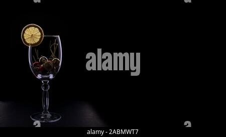 Bright wine glass silhouette isolated on a dark leather background. Christmas and New year design. Dark mode. The photo for banners and posters. Conce Stock Photo