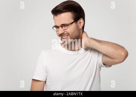 Unhealthy man in glasses massage neck suffering from pain Stock Photo