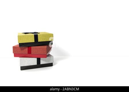 three gift boxes in red silver and gold isolated on white background Stock Photo
