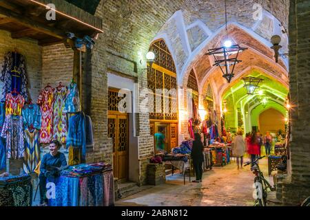 BUKHARA, UZBEKISTAN - APR 30, 2019: Evening street sales in the Historic Centre of Bukhara, Uzbekistan. Stock Photo