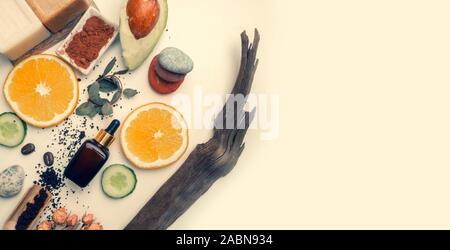 Self care products from natural organic ingredients. Modern medicine, apothecary. Butters, soap, serum, scrub, orange slices, avocado, stones for Stock Photo