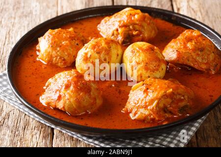 Doro wat made from chicken and hard-boiled eggs is the most popular traditional food in Ethiopia close-up in a plate on the table. Horizontal Stock Photo