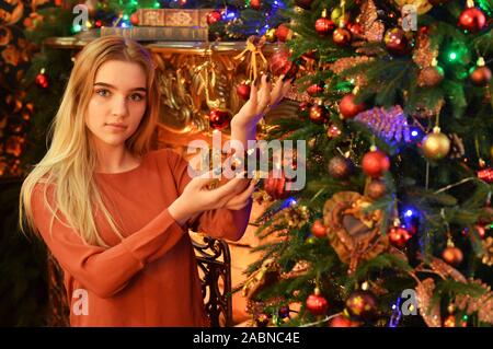 Portrait of teenage girl decorating Christmas tree