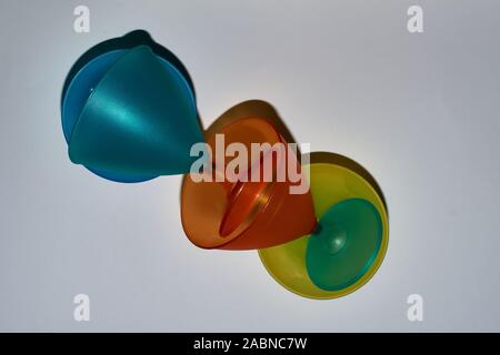 yellow, orange, blue, turquoise mug from top to bottom, top-down photographed. Stock Photo