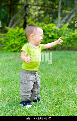 Sweet Sad Toddler Boy Crying in the Grass Stock Photo