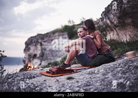 Thoughtful look. Two loved people have camping in the evening at the end of theirs walk through woods and mountains Stock Photo