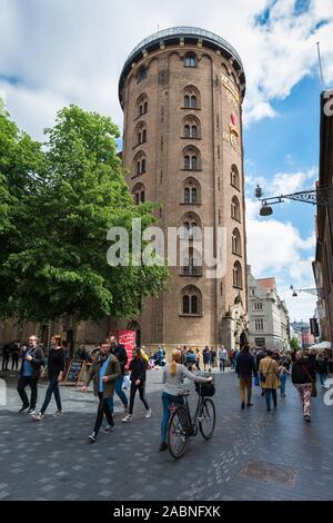 Round Tower Copenhagen, view of the landmark Rundetaarn building with people walking along Kobmagergade in central Copenhagen, Denmark. Stock Photo