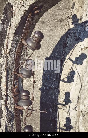 Close up picture of old rusty barbed wire fence, selective focus, color toning applied. Stock Photo