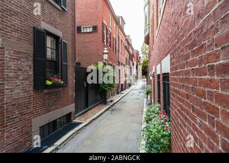 Narrow alley lined with traditional American brick residential buildings Stock Photo