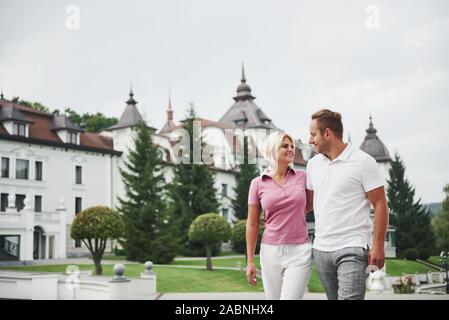 A handsome couple, man and a woman walking together holding hands. The concept of middle-aged relationships Stock Photo