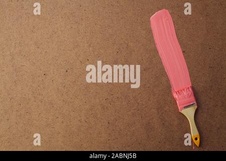 brush with paint to paint the wall paint structure as a background Stock Photo