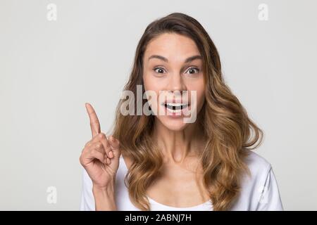 Smiling excited woman finger up gesture, good new idea Stock Photo