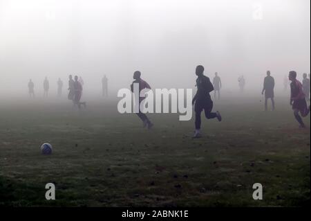 Footballers playing in Misty conditions on the Warren Avenue Playing Fields Stock Photo