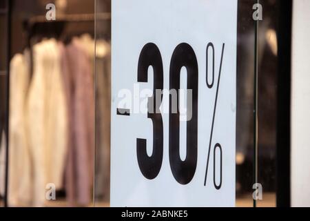 Munich, Germany. 28th Nov, 2019. In the shop window of a store in Munich city centre, a 30 percent discount campaign is advertised. Credit: Jennifer Weese/dpa/Alamy Live News Stock Photo