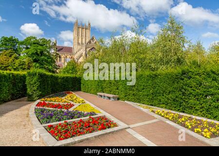 A colourful herbaceous border in Bishop Peter's Garden in a corner of the Bishop's Palace grounds in Wells, Somerset, England, UK Stock Photo