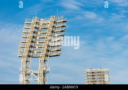 Stadium lights towers in the daytime against blue sky Stock Photo