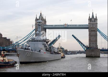 Soil from 70 battle fields of Flanders being shipped into London, passing through the open Tower Bridge where it will form an iconic memorial garden at the  Guards Museum marking the centenary of the Great War in 2014. Stock Photo