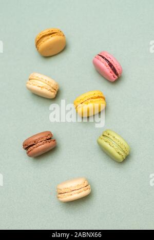 Colored tasty  macaroons over a green background. Stock Photo