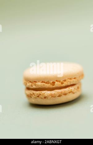 Colored tasty  macaroons over a green background. Stock Photo