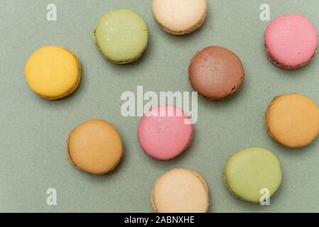 Colored tasty  macaroons over a green background. Stock Photo