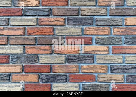 Closeup of a colorful brick wall made of multicolored bricks Stock Photo