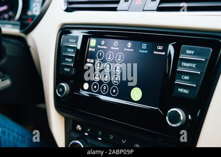 Strasbourg, France - Dec 13, 2016: Side view of digital screen inside luxury car interior with Apple CarPlay system on the large digital dashboard dialing number menu Stock Photo