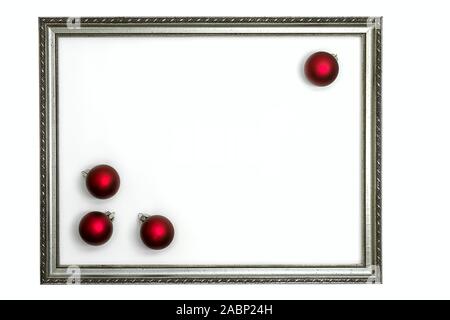 four glitter balls framed by a silvery old picture frame on white background Stock Photo