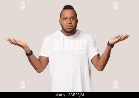 Doubtful African American man shrugging shoulders, feeling confused Stock Photo