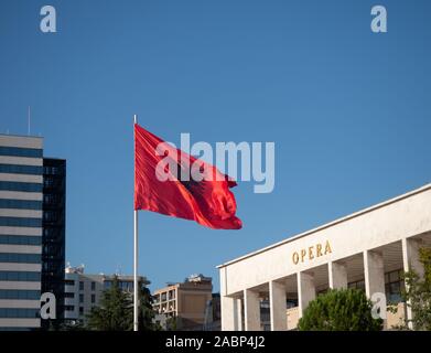 Tirana, Albania - September 29, 2019: Unfurled Albanian flag with a double-headed eagle in black against a red background. Part of the National Theatr Stock Photo