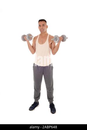 A east Indian man working out with two dumbbells in his track pants, isolated for white background Stock Photo