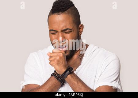 Unhealthy African American man coughing, suffering from flu or cold Stock Photo
