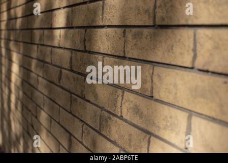 Yellow brick wall. The texture of the brick wall. Background for designers. Light and shadow on a beige brick wall with brick Stock Photo