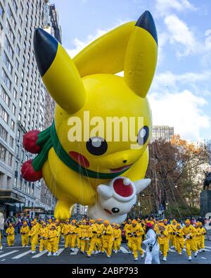 New York, USA,  28 November 2019.  Performers carry a Pikachu balloon at the Macy's Thanksgiving Parade in New York City.   Credit: Enrique Shore/Alamy Live News Stock Photo