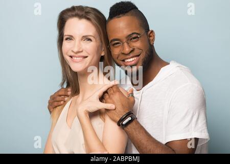 Smiling diverse couple in love posing for photo together Stock Photo